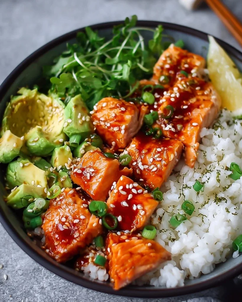 A delicious bowl of Honey Sriracha Salmon with vegetables and rice.