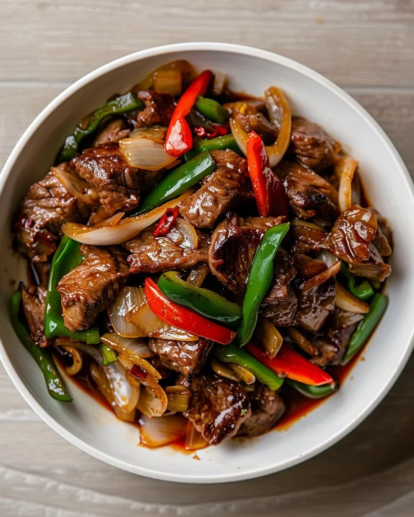 Sizzling Chinese pepper steak with onions served on a plate