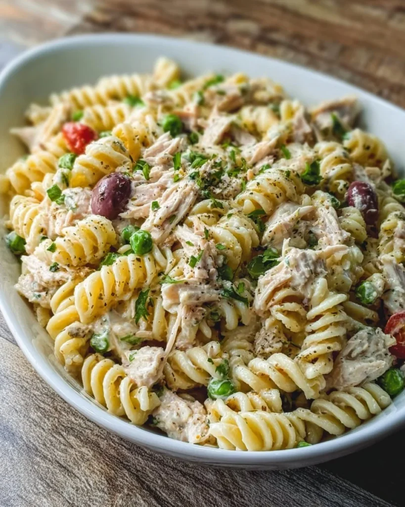 Bowl of easy tuna pasta salad with colorful vegetables and dressing